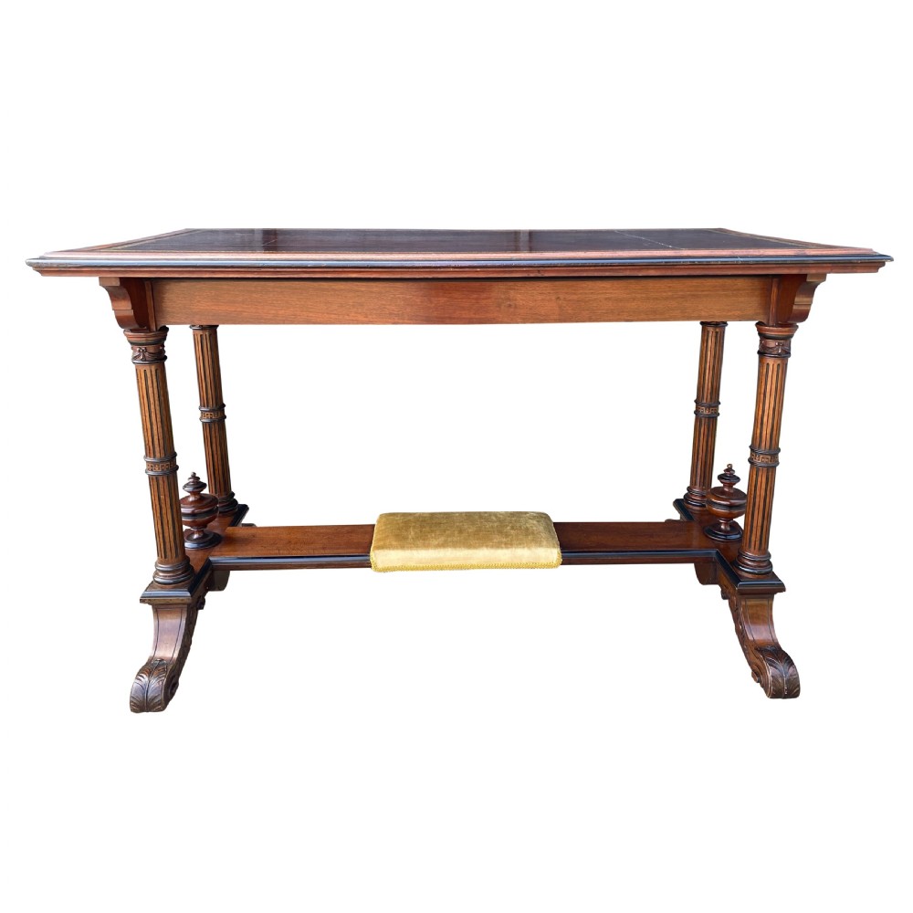 Late nineteenth-century mahogany writing table featuring a dark brown leather inset top with gilded tooling, fluted legs, and a central velvet-padded footrest on a low stretcher. View III