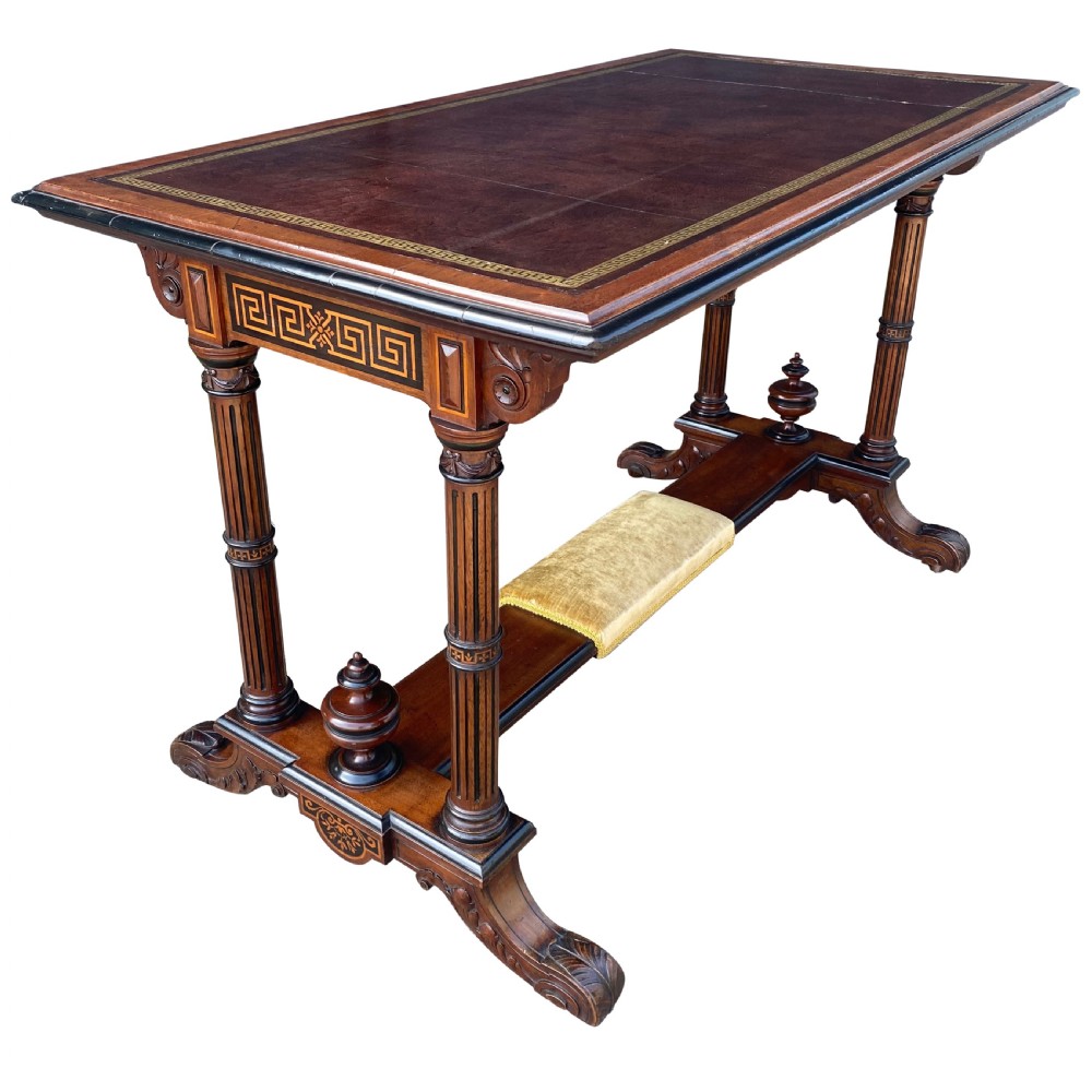 Late nineteenth-century mahogany writing table featuring a dark brown leather inset top with gilded tooling, fluted legs, and a central velvet-padded footrest on a low stretcher. View VII