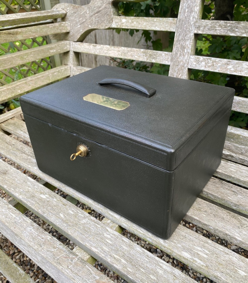 An open 19th-century dark leather jewellery box revealing a green velvet compartmentalised tray and brass lock mechanism. View III