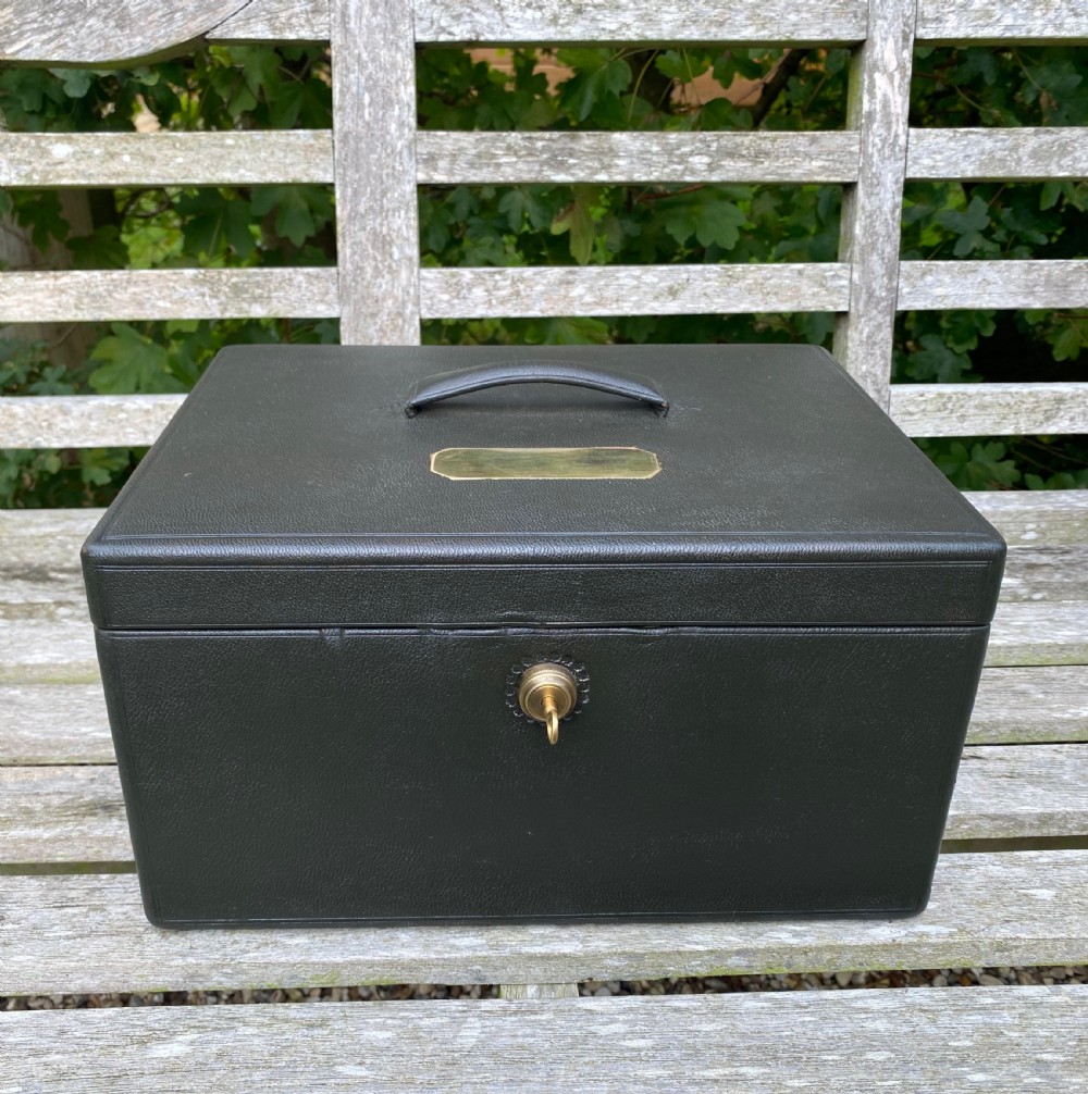 An open 19th-century dark leather jewellery box revealing a green velvet compartmentalised tray and brass lock mechanism. View VIII