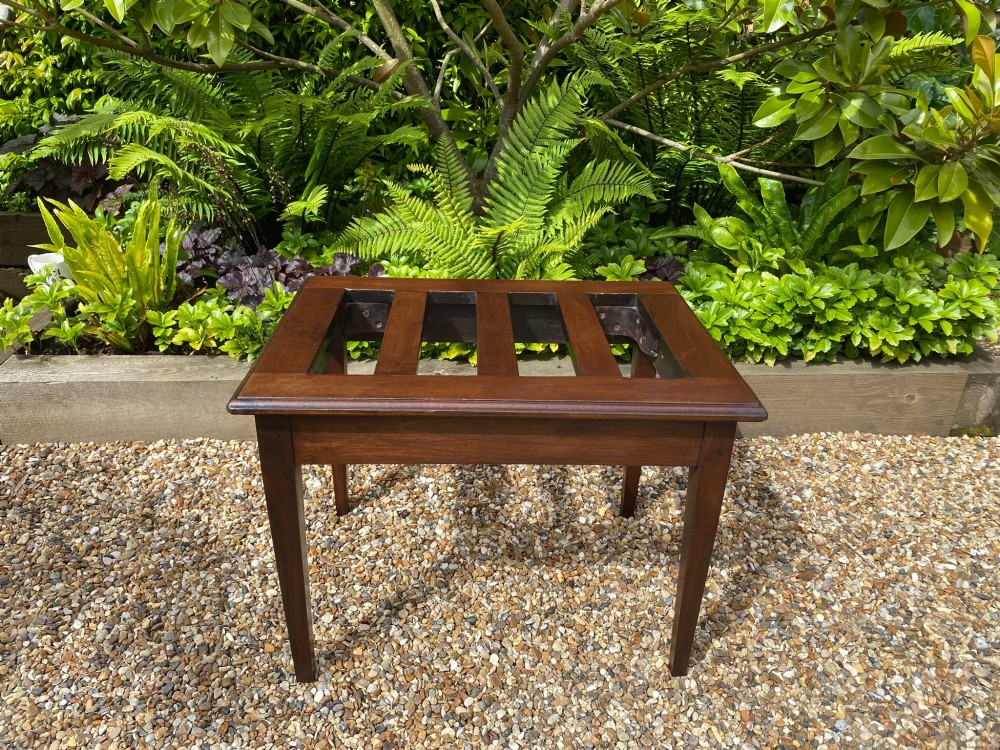 A dark mahogany slatted luggage stand featuring four central slats and four straight tapered square legs. View II