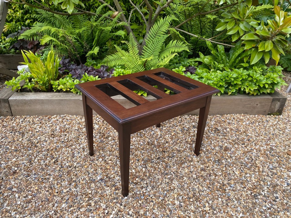 A dark mahogany slatted luggage stand featuring four central slats and four straight tapered square legs. View III