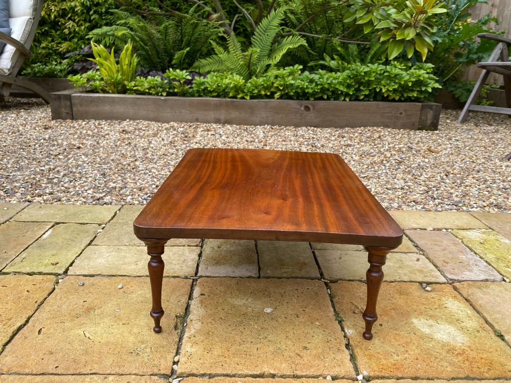 A low mahogany bed tray table featuring a rectangular flat top and four short turned legs. View II