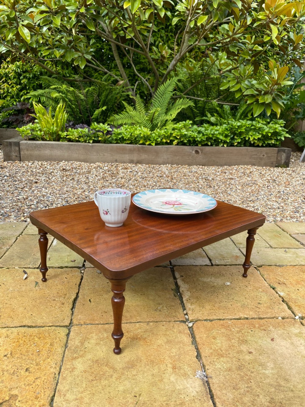 A low mahogany bed tray table featuring a rectangular flat top and four short turned legs. View III