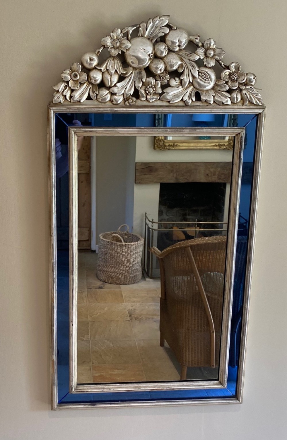 A vertical rectangular Venetian wall mirror featuring a carved silvered fruit pediment, silver gilt framing, and cobalt blue glass border panels. View II