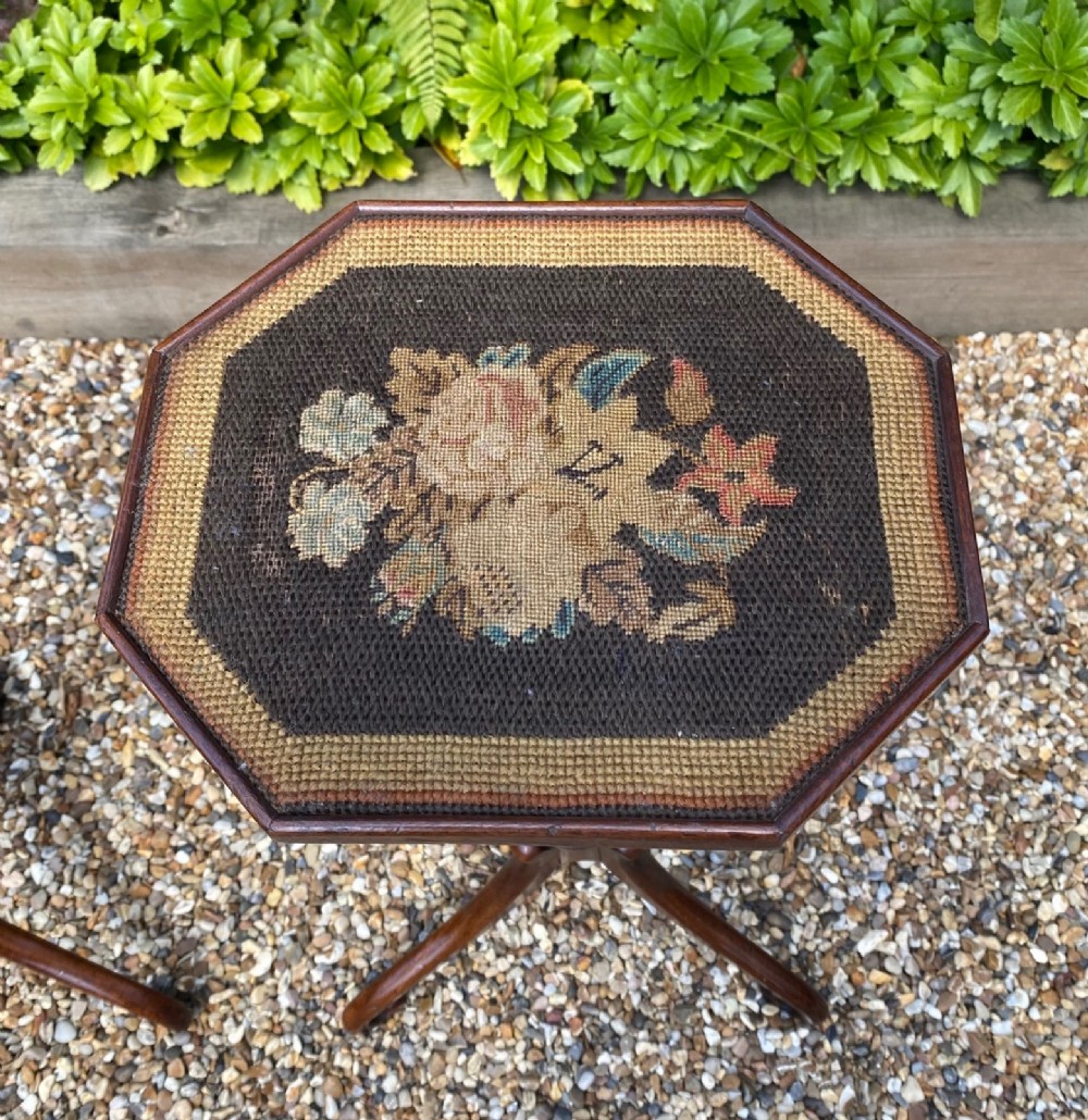 A pair of antique Georgian mahogany wine tables with octagonal needlework tops, ring-turned stems, and tripod bases with scroll feet. View IV