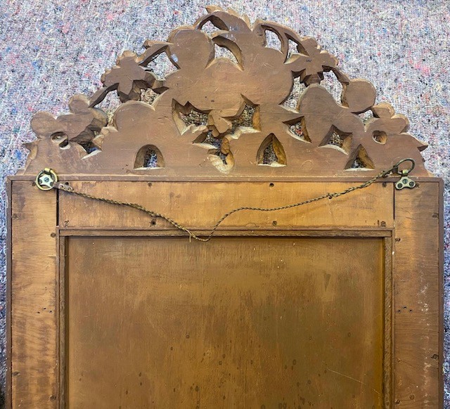 A vertical rectangular Venetian wall mirror featuring a carved silvered fruit pediment, silver gilt framing, and cobalt blue glass border panels. View V