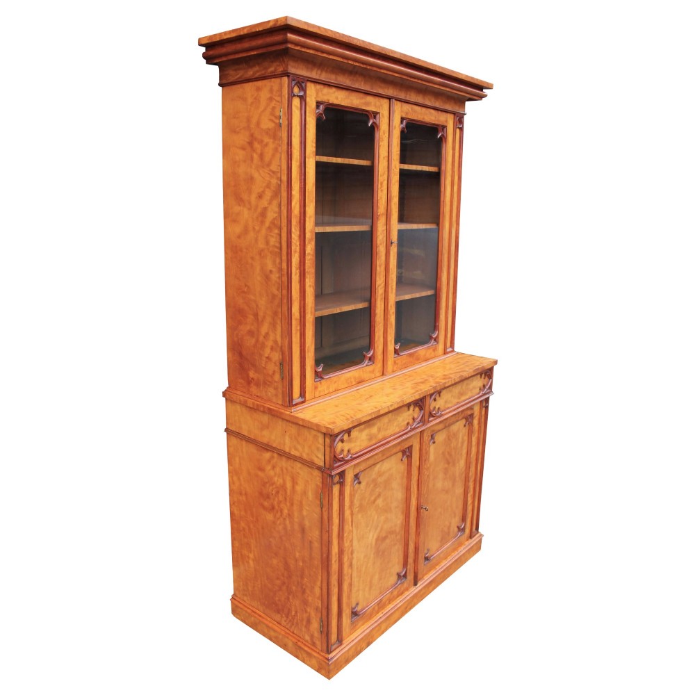 A 19th century Gothic Revival two-part satinwood bookcase featuring glazed upper doors with Gothic tracery and a matching lower cupboard section. View III