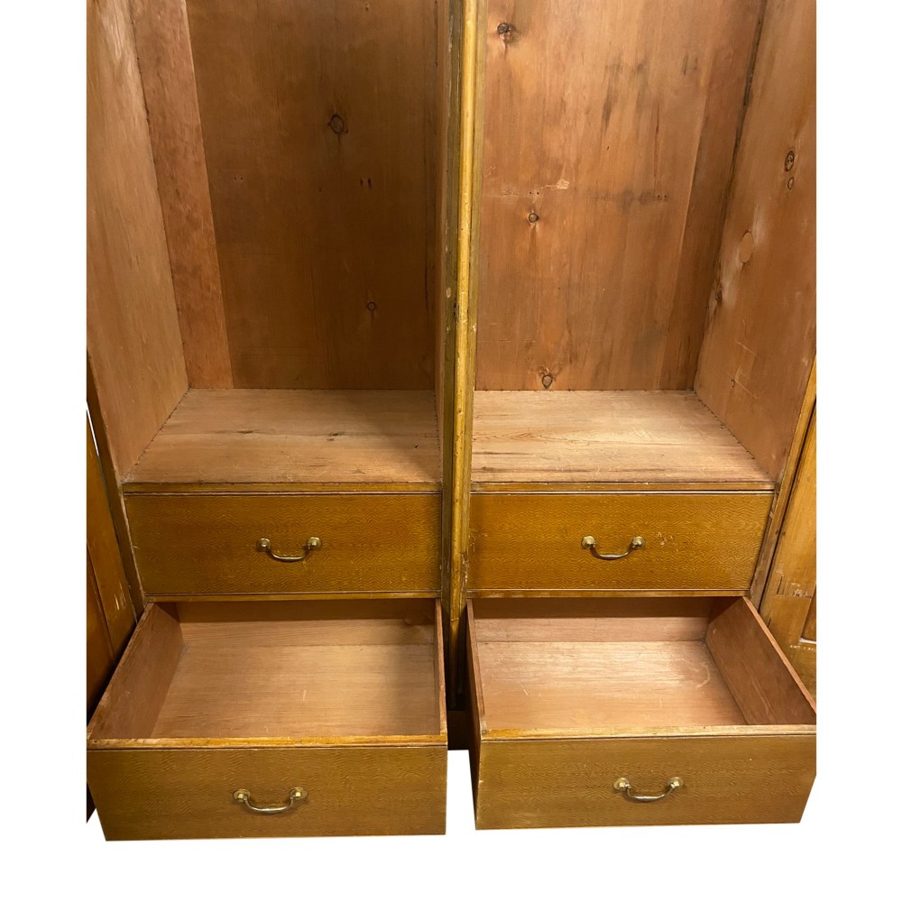 A nineteenth-century two-door wardrobe featuring a scumble faux oak grain paint finish, twin recessed panels, a stepped upper cornice, and brass keyhole fittings. View V