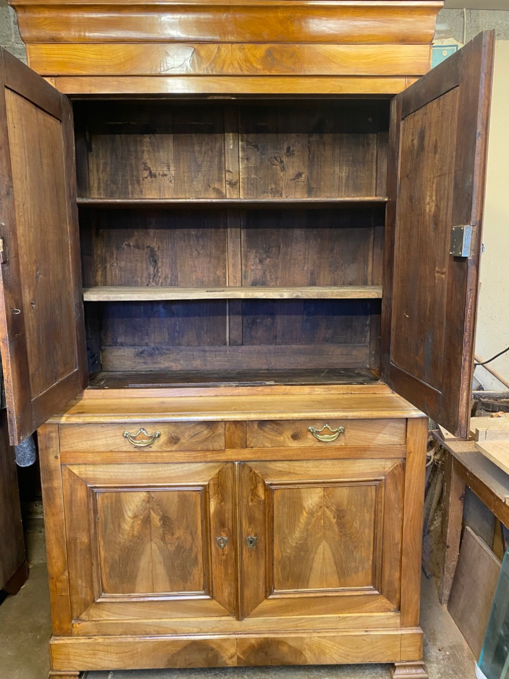 A 19th-century French two-part solid cherry wood housekeeper cupboard with double doors on the upper and lower sections and two central drawers. View VI