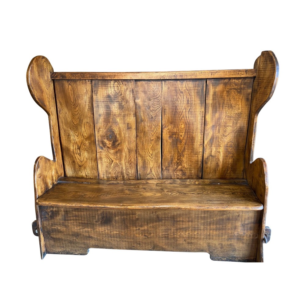 A high-backed 19th-century solid elm box settle with shaped side wings, panelled backrest, and integrated storage seat. View II