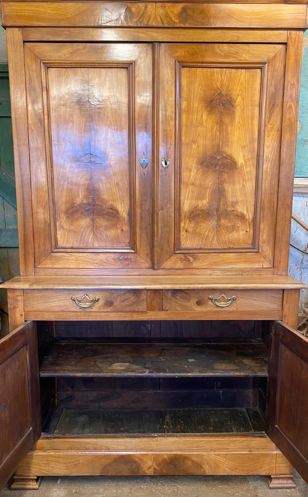A two-part French solid cherry wood housekeepers cupboard featuring double fielded panel doors, twin drawers, and brass escutcheons. View VII