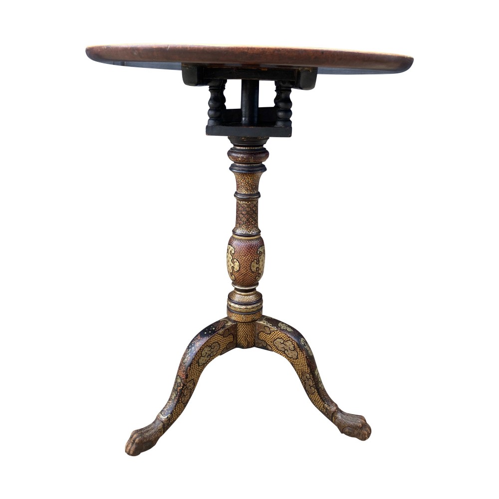 An Anglo-Indian tripod side table featuring an oval tray top supported by an intricately lacquered turned column and three cabriole legs. View V