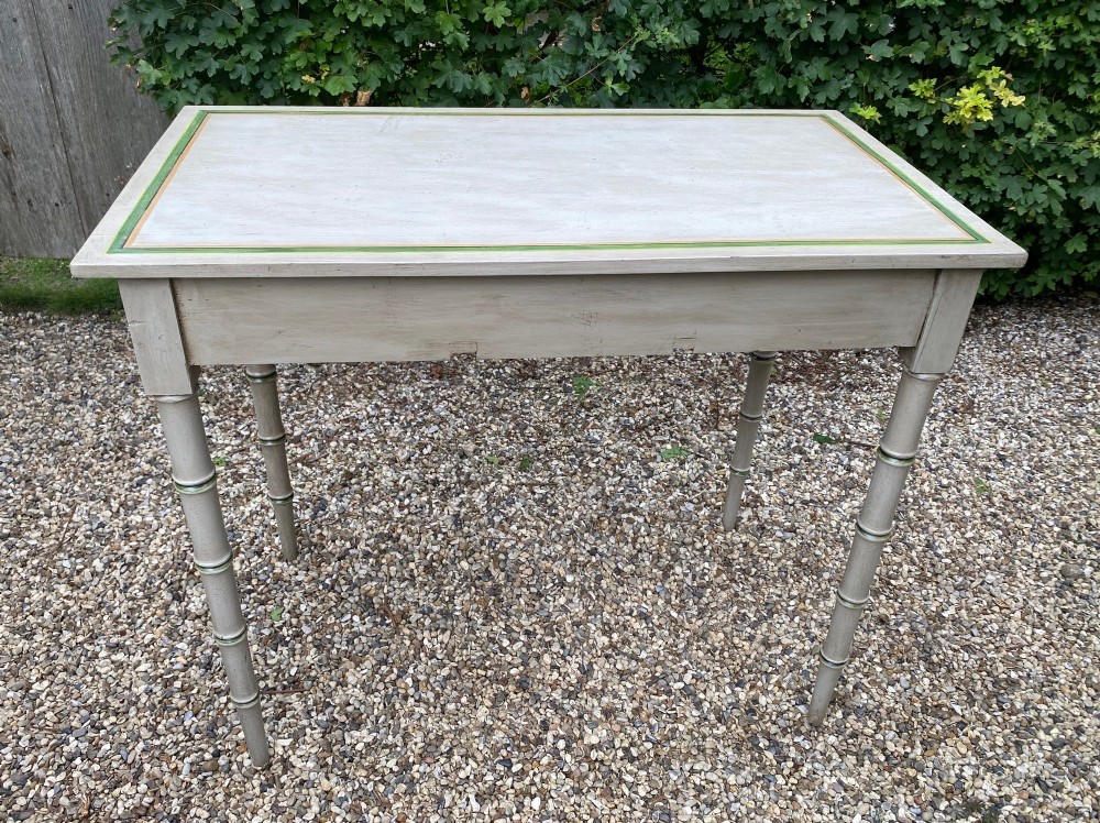 A light grey painted Regency side table featuring green border lining, three drawers with turned wooden knobs, and four legs shaped like bamboo. View IV