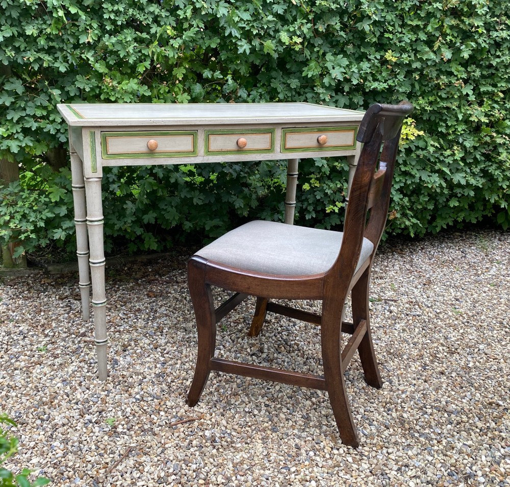 A light grey painted Regency side table featuring green border lining, three drawers with turned wooden knobs, and four legs shaped like bamboo. View V