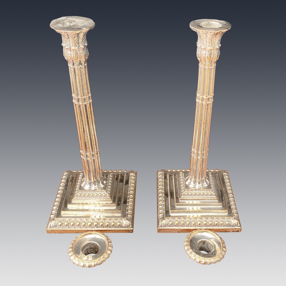 A pair of Georgian silver-plated candlesticks featuring fluted column stems and tiered square bases with beaded borders. View III