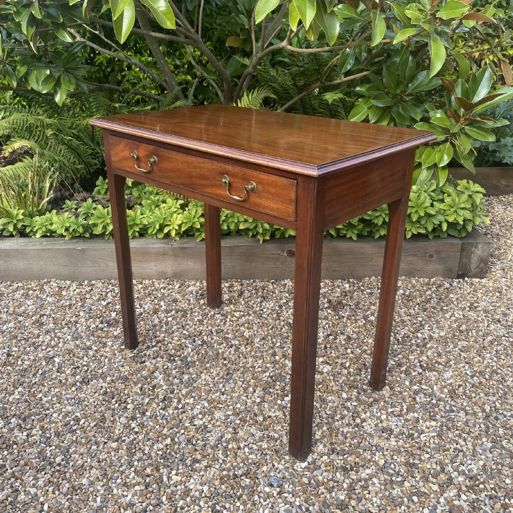 An 18th-century Georgian mahogany side table featuring a single drawer with two brass swan-neck handles and square legs.