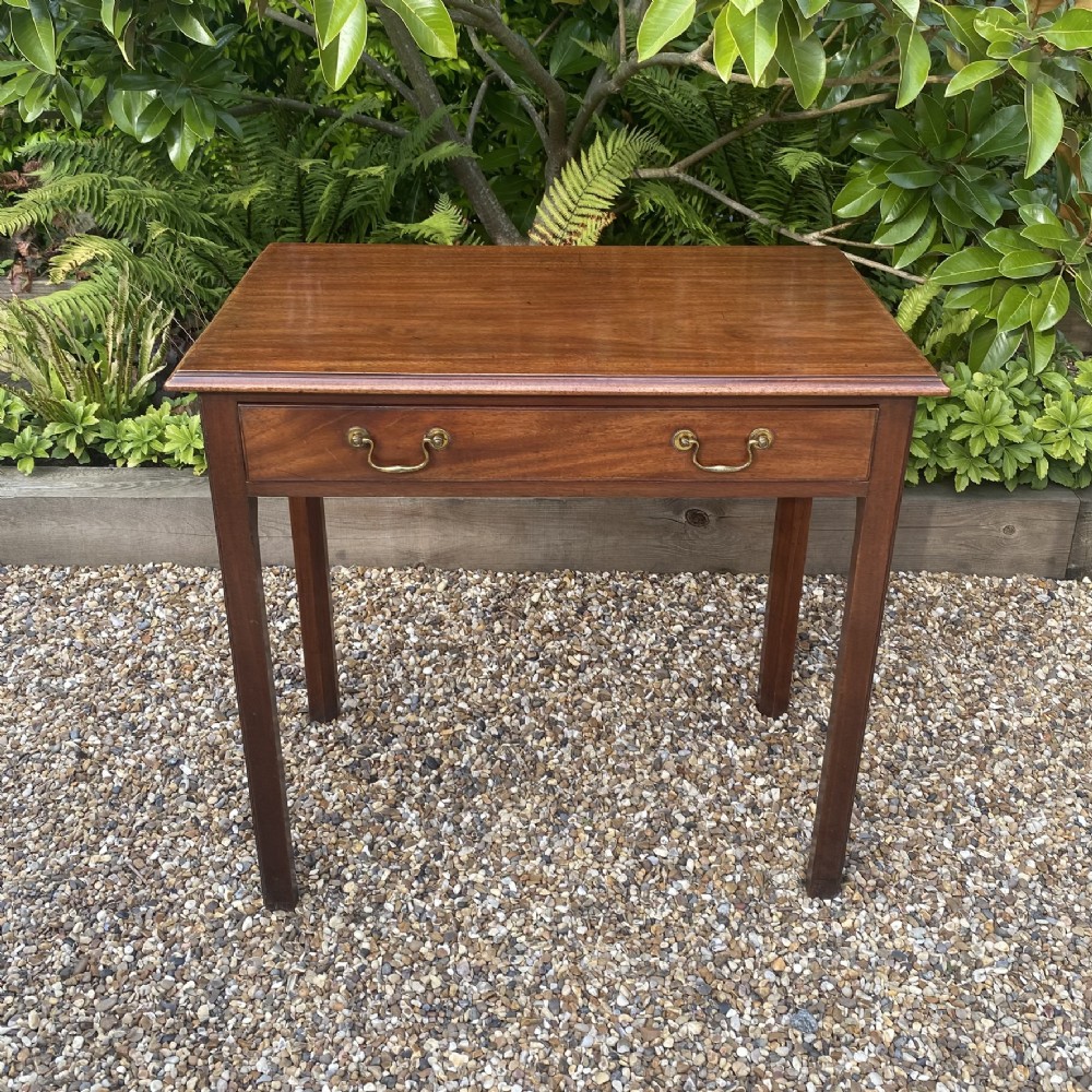 An 18th-century Georgian mahogany side table featuring a single drawer with two brass swan-neck handles and square legs. View V
