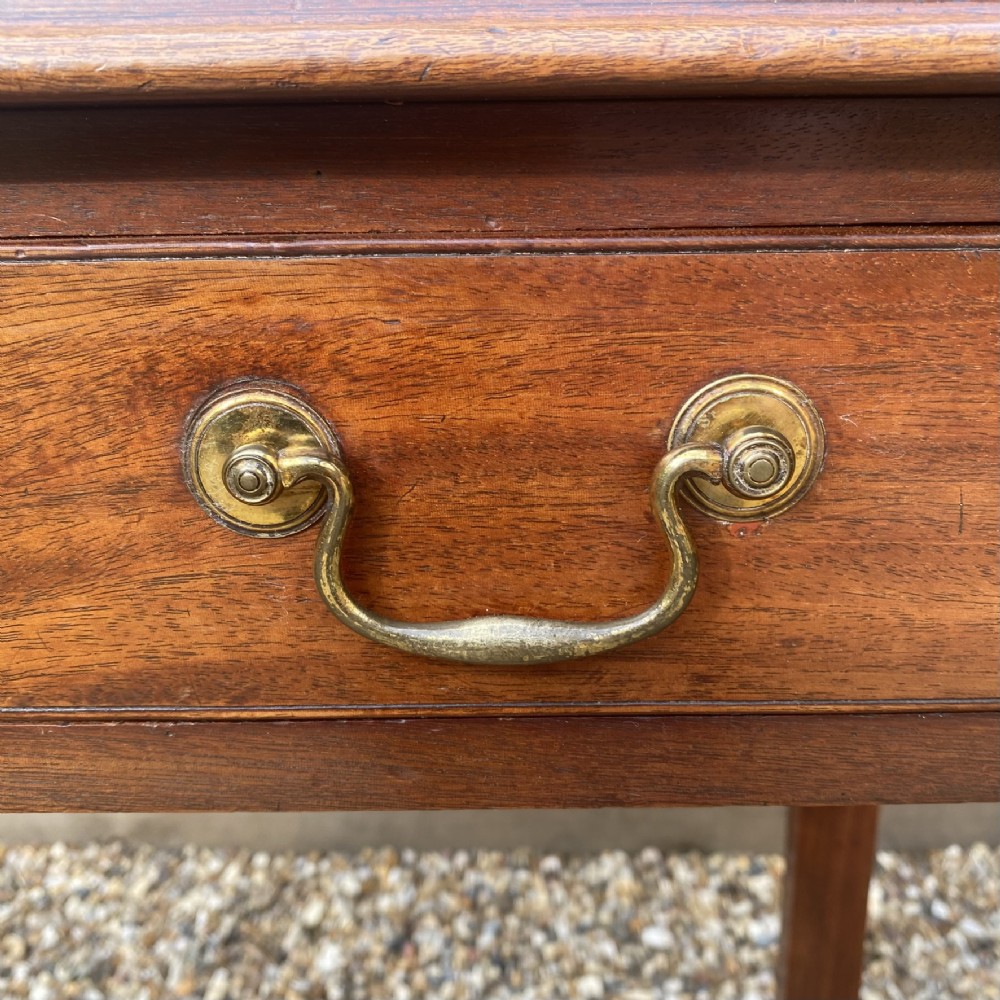 An 18th-century Georgian mahogany side table featuring a single drawer with two brass swan-neck handles and square legs. View VII