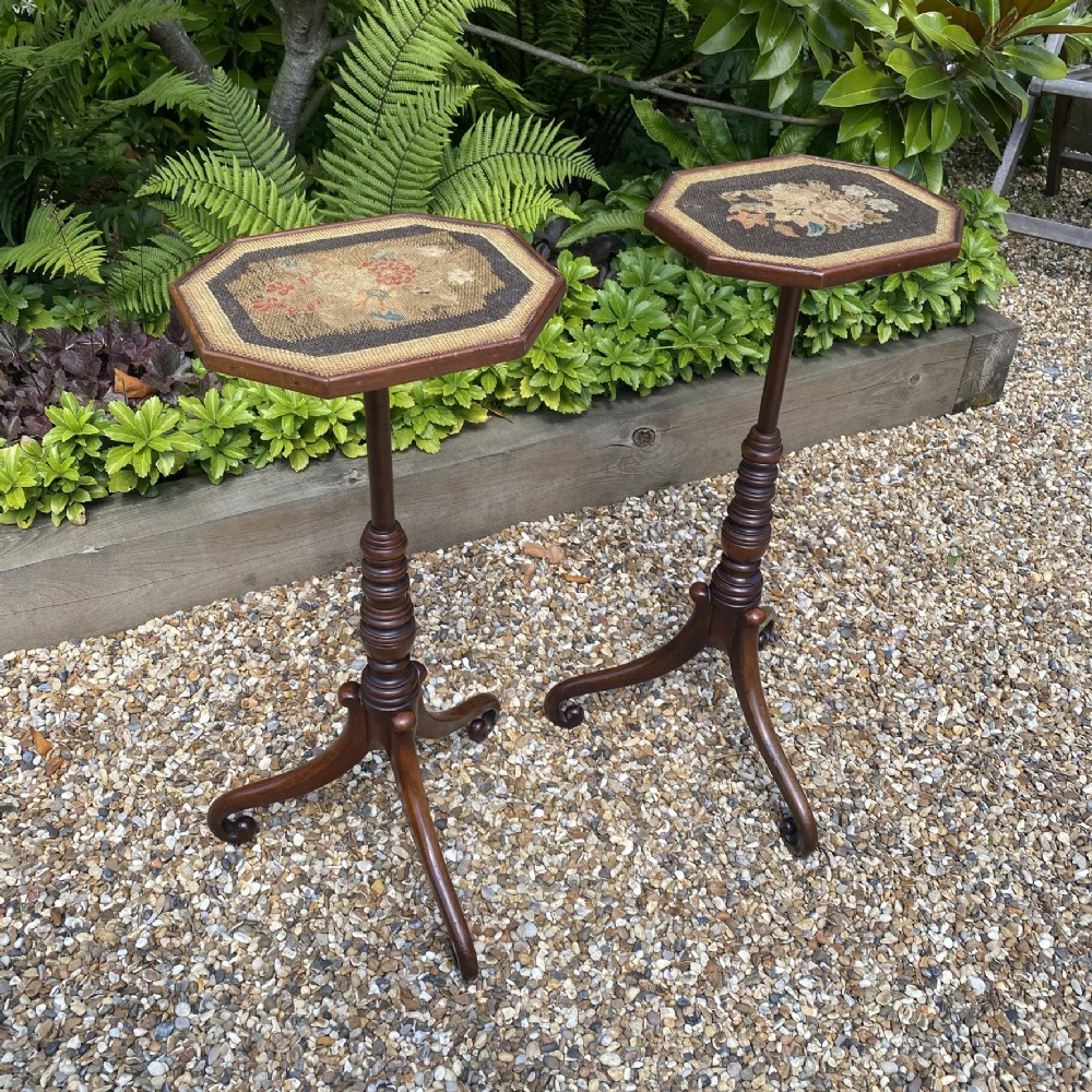A pair of Georgian dark mahogany wine tables featuring octagonal tops with floral needlepoint inserts, slender ring-turned pedestals, and tripod downswept legs. View II