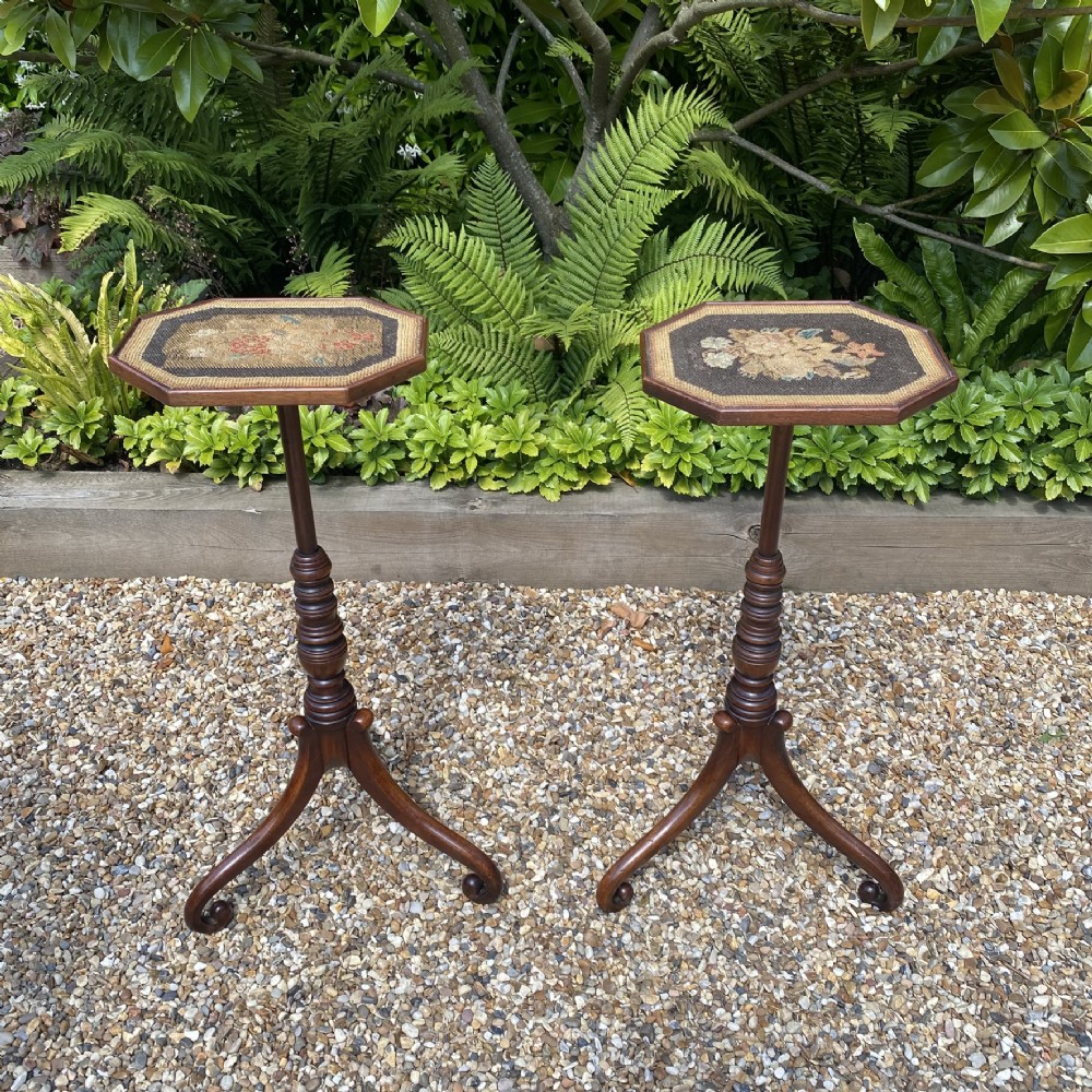A pair of Georgian dark mahogany wine tables featuring octagonal tops with floral needlepoint inserts, slender ring-turned pedestals, and tripod downswept legs. View III