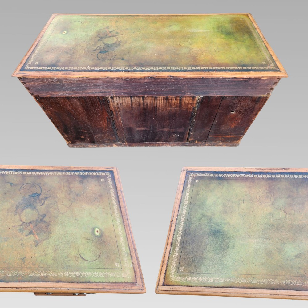An antique Victorian pine pedestal writing desk featuring a green leather inset top and twin pedestals fitted with drawers and brass ring handles. View III