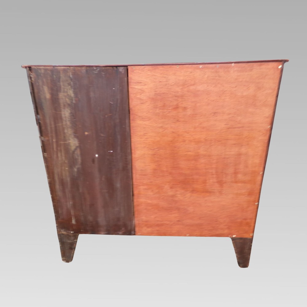 A Victorian mahogany chest of drawers featuring two short over three long drawers with satinwood crossbanding and oval brass handles. View X