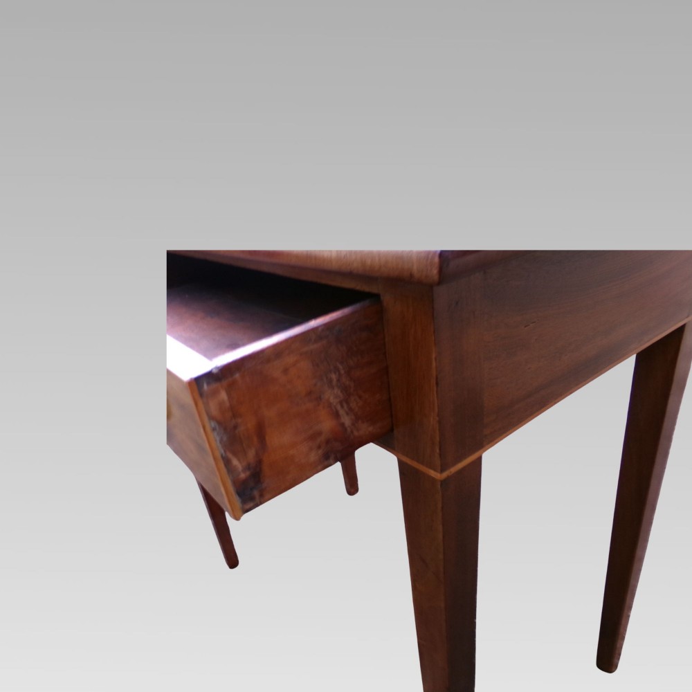 A George III mahogany side table with fine string inlay around the single drawer front and brass ring handles, raised on square tapered legs. View VII