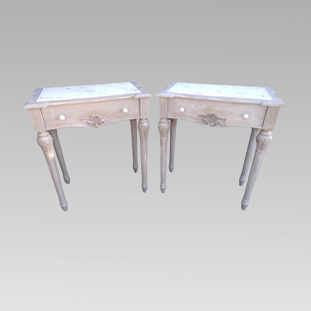 A pair of distressed grey painted French bedside tables featuring white marble inset tops and carved wooden legs. View II