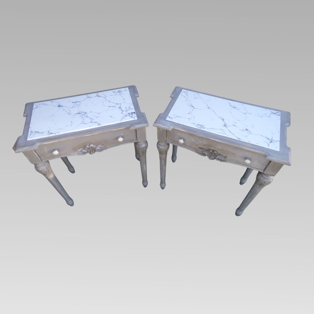 A pair of distressed grey painted French bedside tables featuring white marble inset tops and carved wooden legs. View III