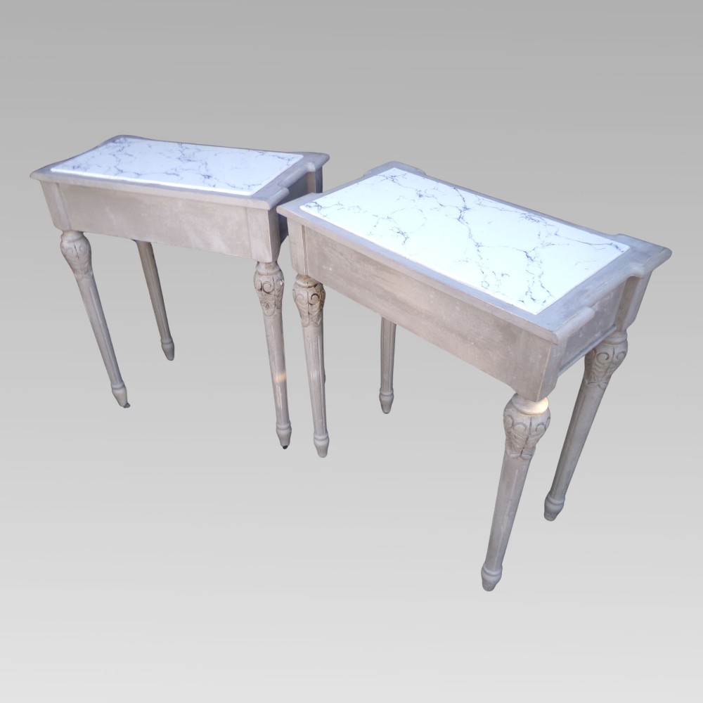 A pair of distressed grey painted French bedside tables featuring white marble inset tops and carved wooden legs. View VII