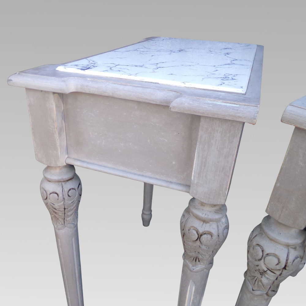 A pair of distressed grey painted French bedside tables featuring white marble inset tops and carved wooden legs. View VIII