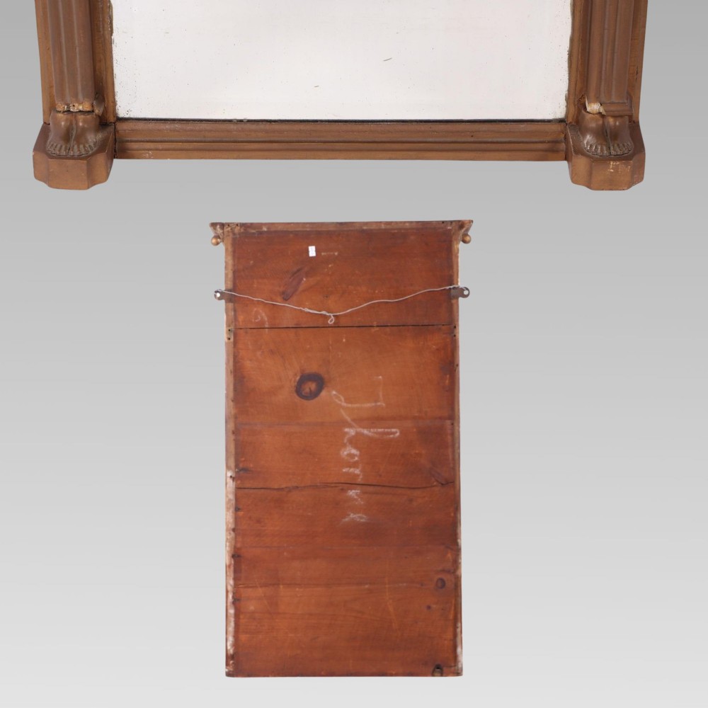 A 19th-century giltwood pier mirror featuring Egyptian Revival pharaoh head pilasters, a moulded ball cornice, and a relief frieze panel above the rectangular glass. View III