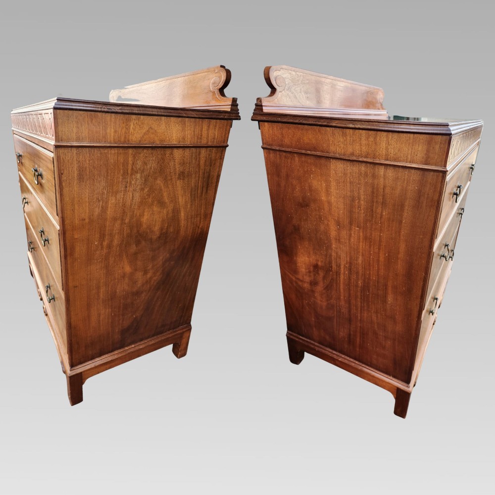 A Victorian mahogany chest of drawers featuring three horizontal drawers with brass handles, a carved wave frieze, and a shaped apron base. View V