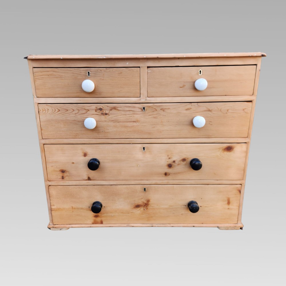 A 19th-century Victorian pine chest of drawers featuring two short over three long drawers with turned white ceramic and black wooden knobs. View II