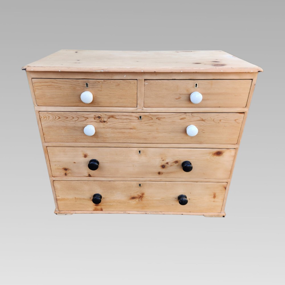 A 19th-century Victorian pine chest of drawers featuring two short over three long drawers with turned white ceramic and black wooden knobs. View III