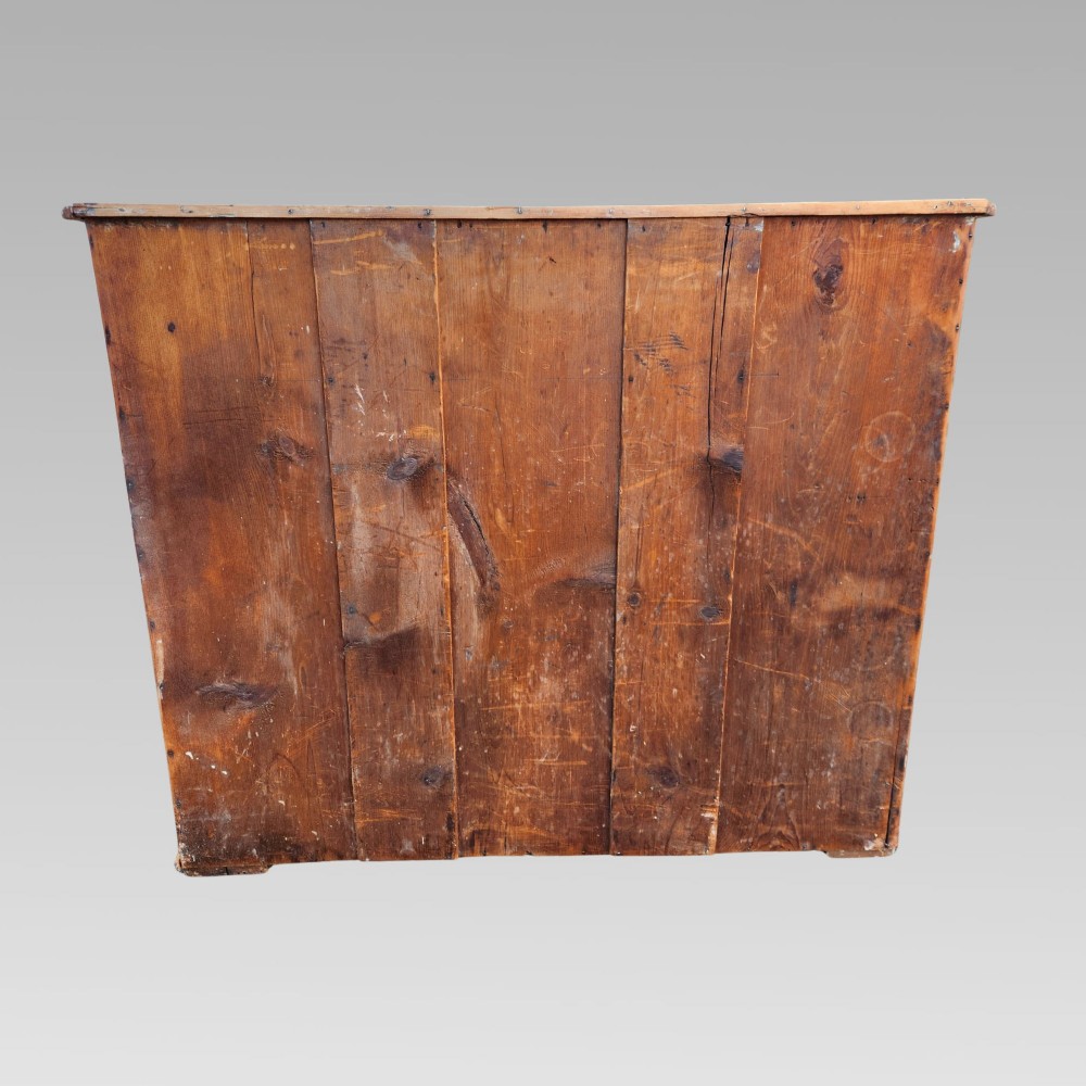 A 19th-century Victorian pine chest of drawers featuring two short over three long drawers with turned white ceramic and black wooden knobs. View VII