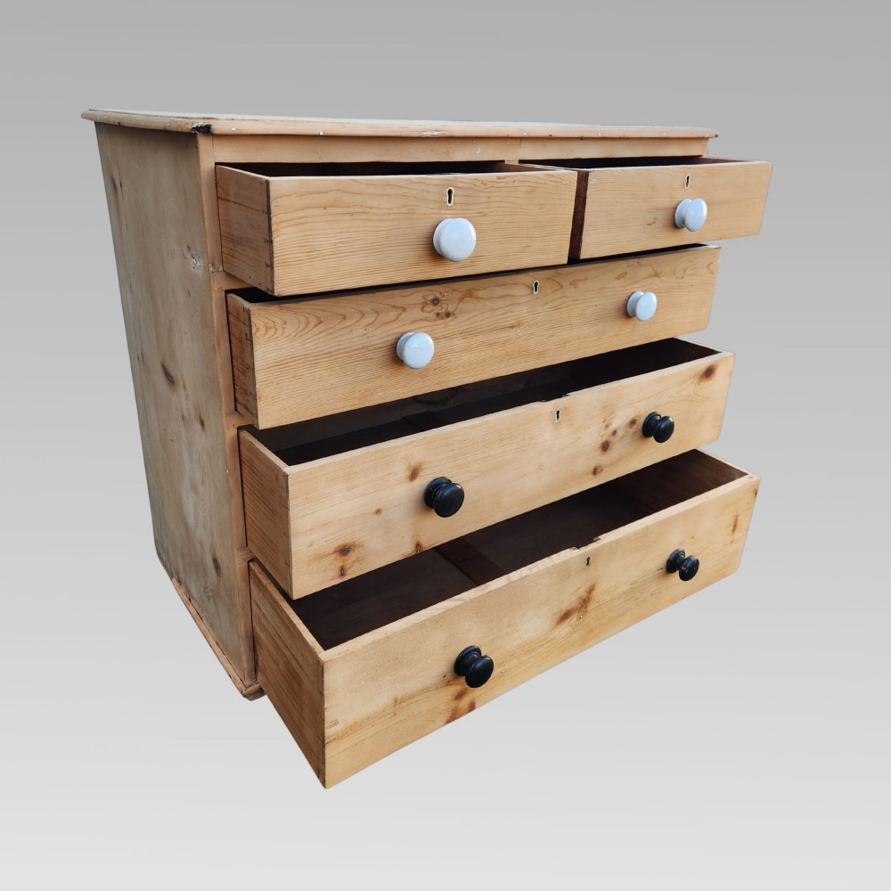 A 19th-century Victorian pine chest of drawers featuring two short over three long drawers with turned white ceramic and black wooden knobs. View VIII