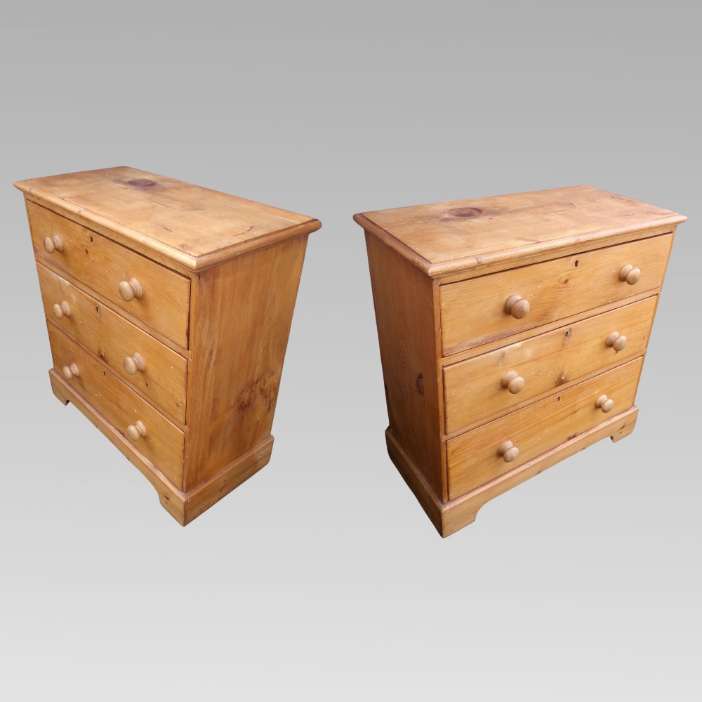 A nineteenth-century Victorian pine chest featuring three full-width drawers with turned wooden handles and keyholes, set on a plinth base. View III