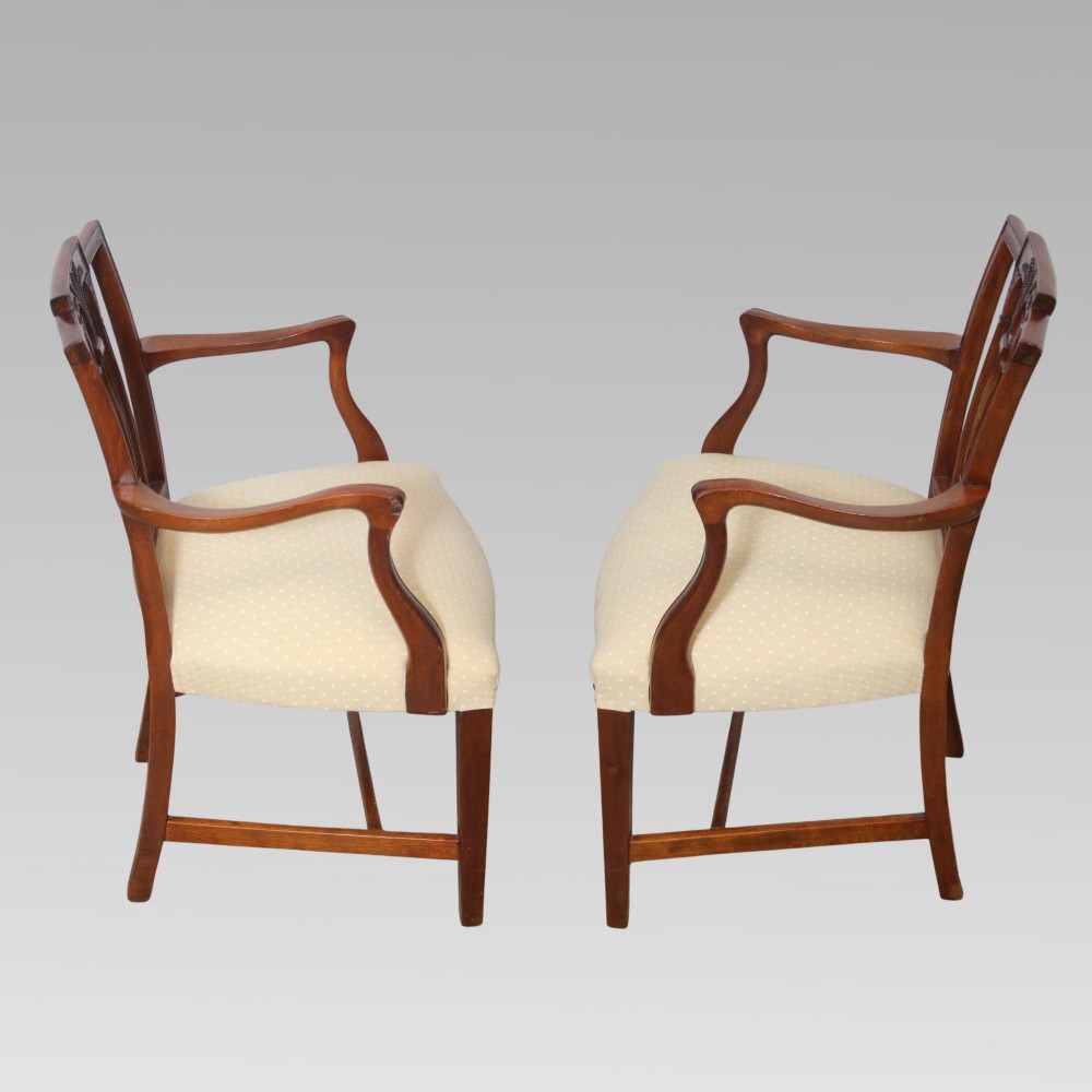 A set of six mahogany Hepplewhite style dining chairs with carved openwork back splats and light cream upholstered seats. View II