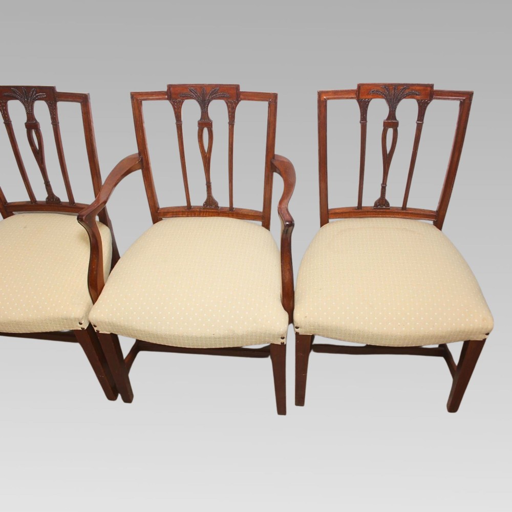 A set of six mahogany Hepplewhite style dining chairs with carved openwork back splats and light cream upholstered seats. View IV