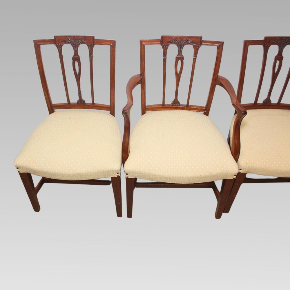 A set of six mahogany Hepplewhite style dining chairs with carved openwork back splats and light cream upholstered seats. View V