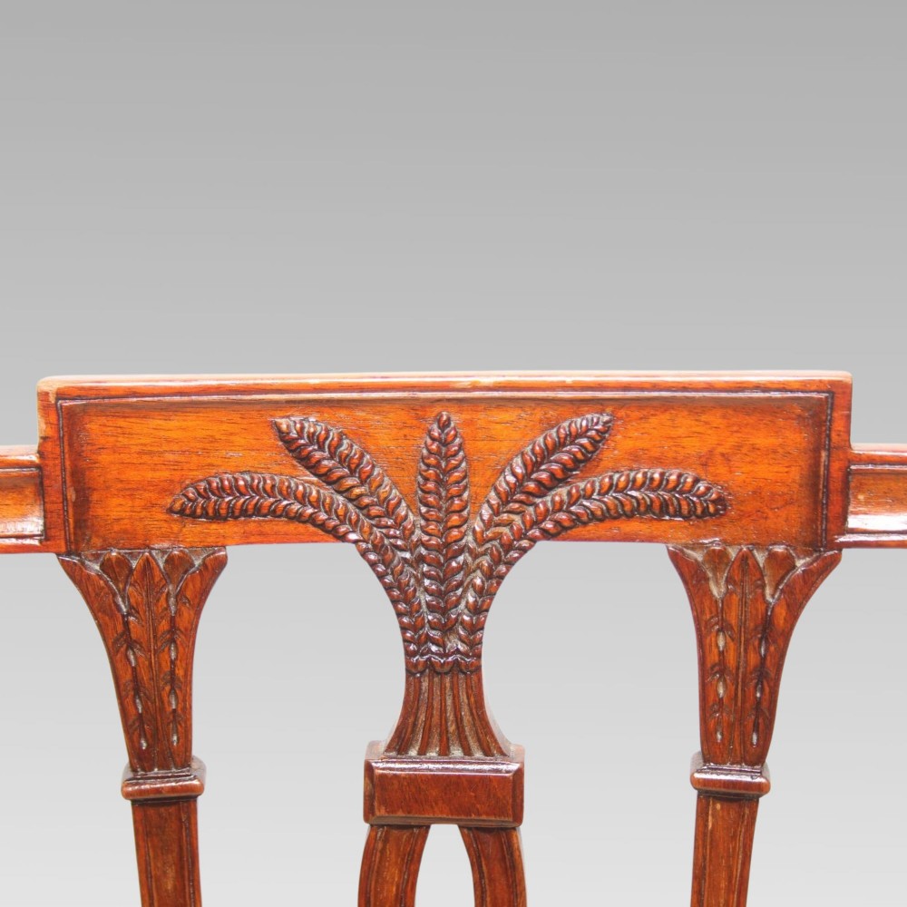 A set of six mahogany Hepplewhite style dining chairs with carved openwork back splats and light cream upholstered seats. View VI
