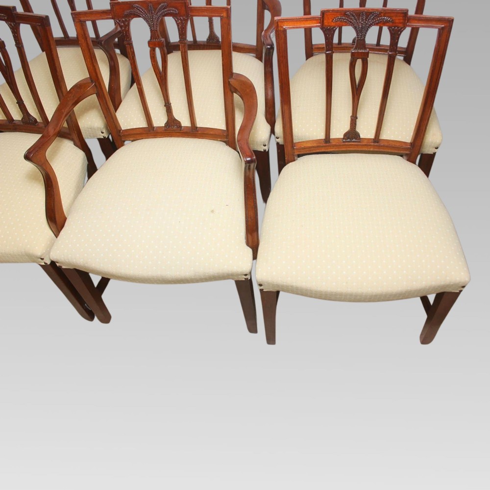 A set of six mahogany Hepplewhite style dining chairs with carved openwork back splats and light cream upholstered seats. View IX