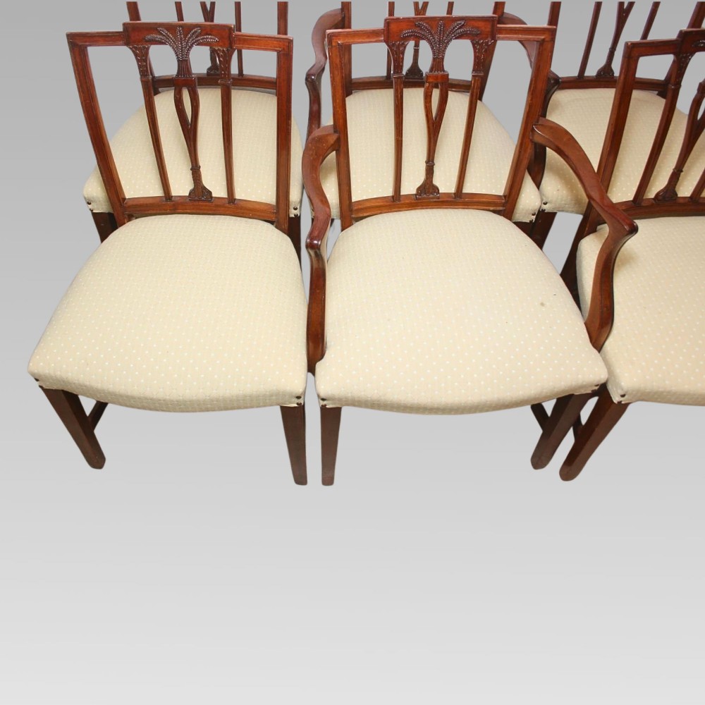 A set of six mahogany Hepplewhite style dining chairs with carved openwork back splats and light cream upholstered seats. View X