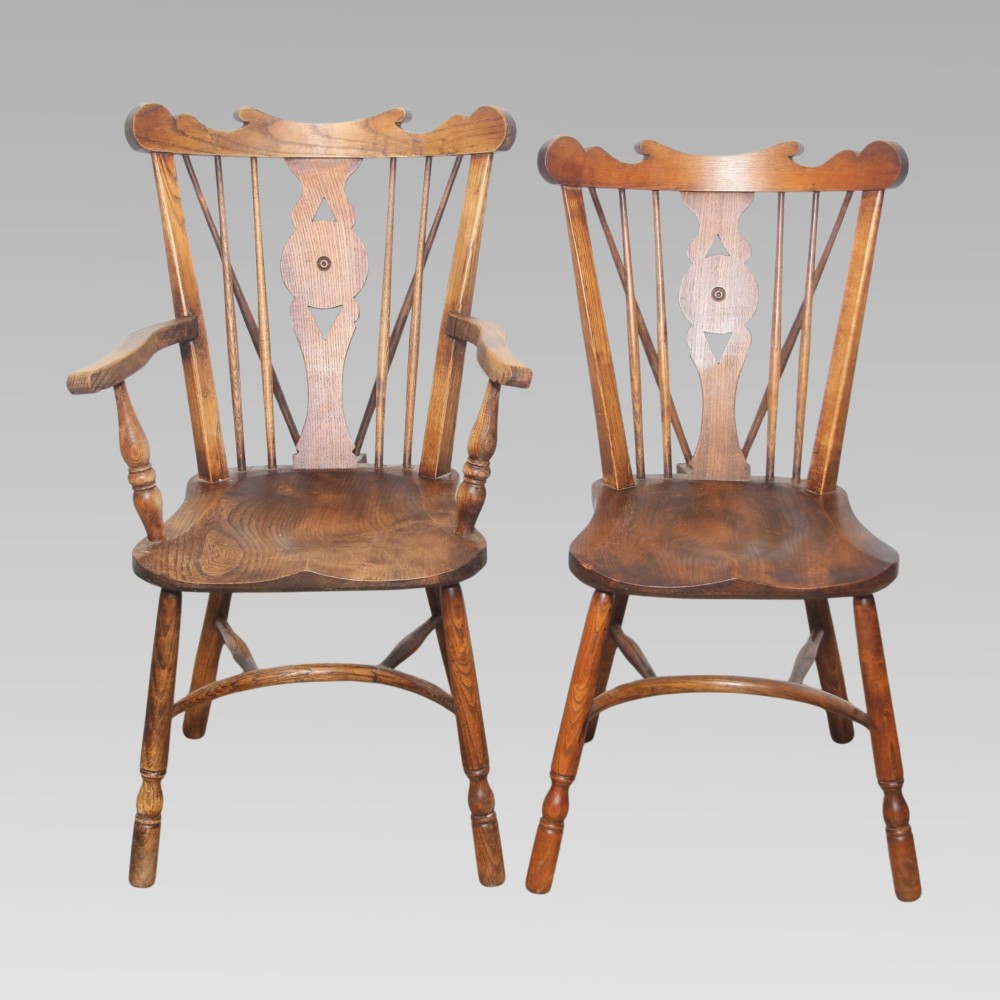 A pair of antique warm brown elm Thames Valley Windsor chairs featuring stick backs, central decorative splats, turned legs, and shaped seats. View II
