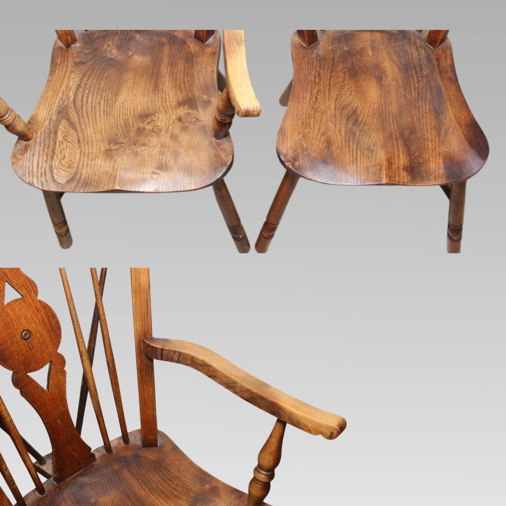 A pair of antique warm brown elm Thames Valley Windsor chairs featuring stick backs, central decorative splats, turned legs, and shaped seats. View VI