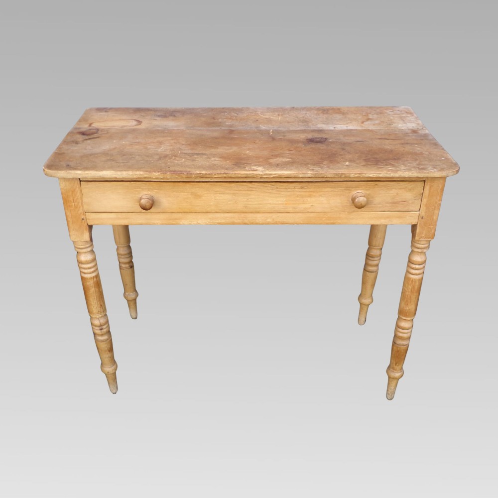 A 19th-century Victorian natural pine side table featuring a single wide drawer with wooden knob handles and slender turned legs.