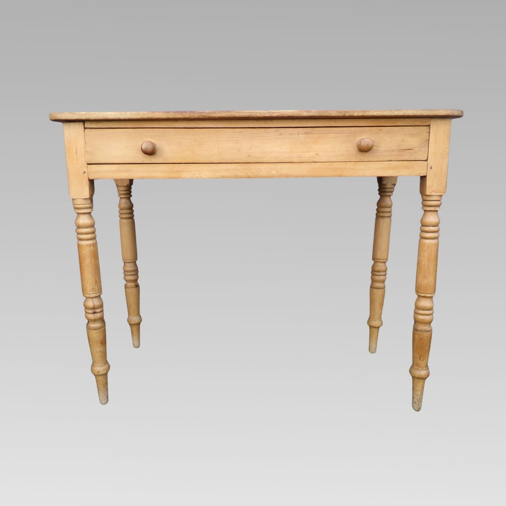 A 19th-century Victorian natural pine side table featuring a single wide drawer with wooden knob handles and slender turned legs. View II