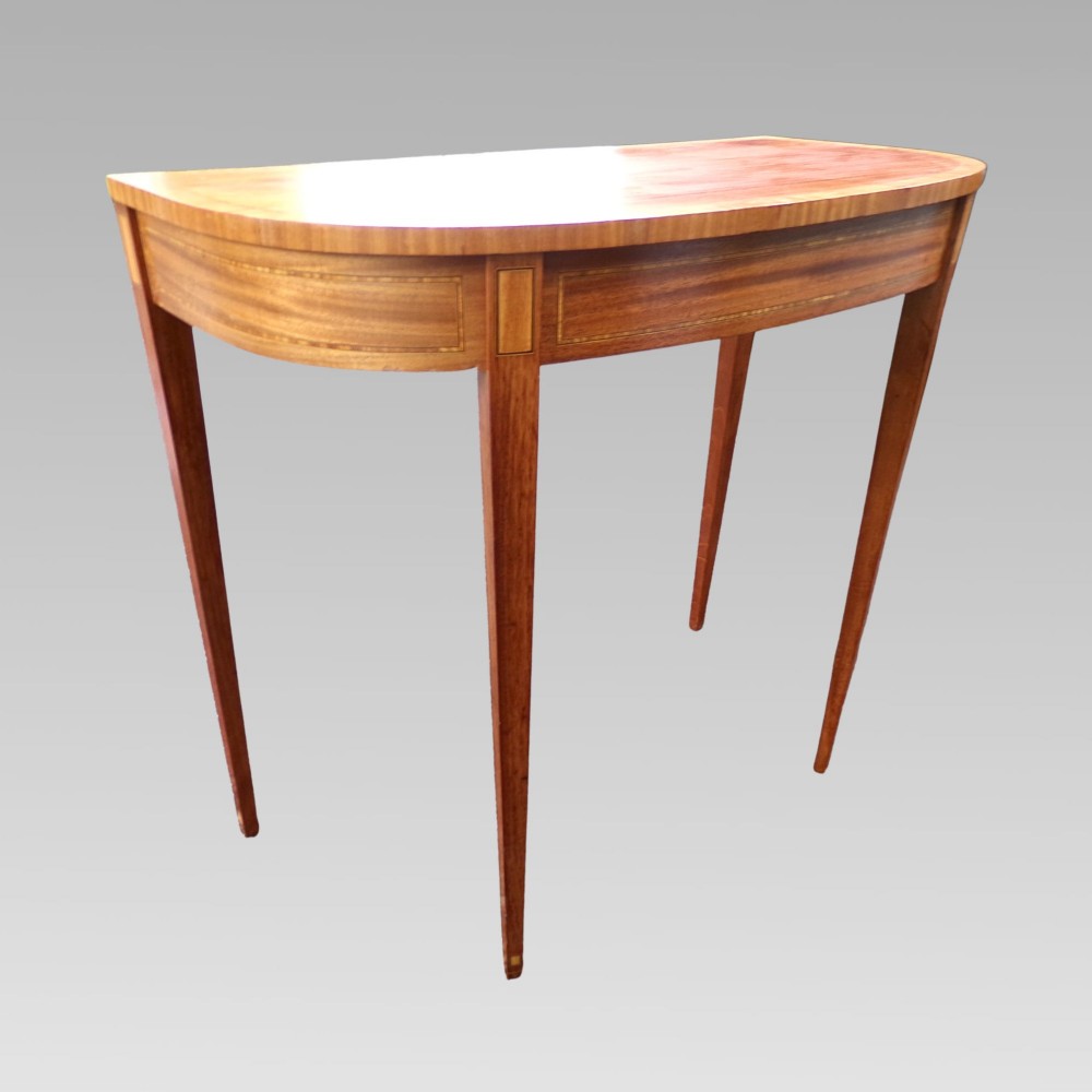 A Georgian style semicircular satinwood console table featuring crossbanded veneer borders and square tapered legs. View III